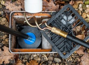Emergency plumber clearing blocked drain in Luton property